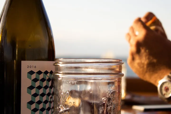 a close up of a bottle and a glass of wine