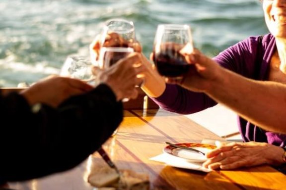 a person drinking water from a wine glass