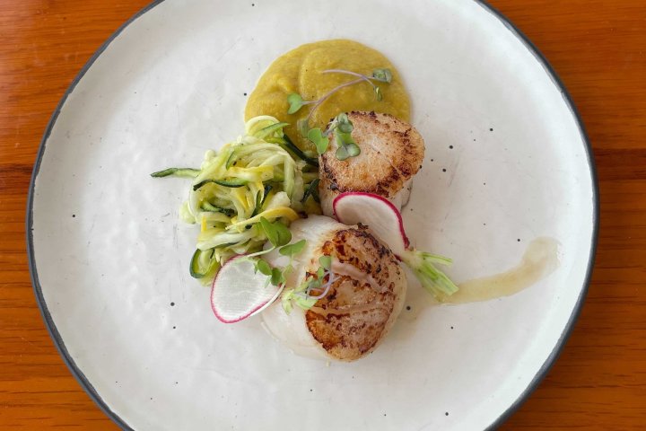 a plate of food sitting on top of a wooden table