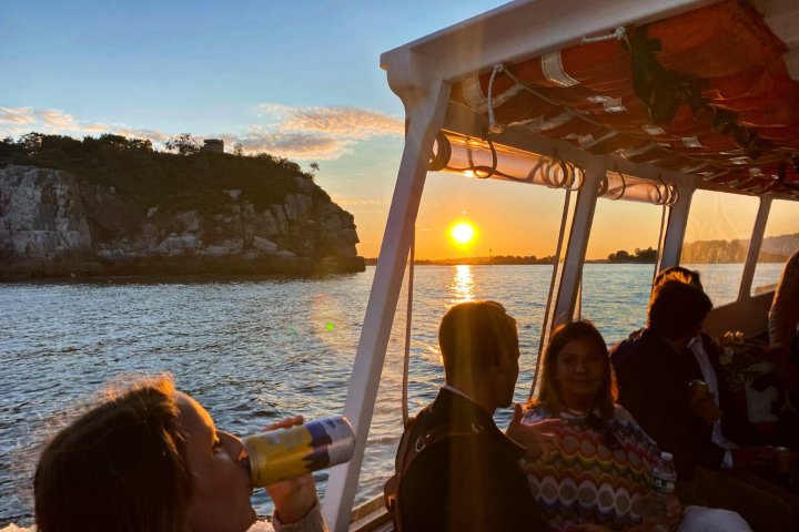 a group of people standing next to a body of water