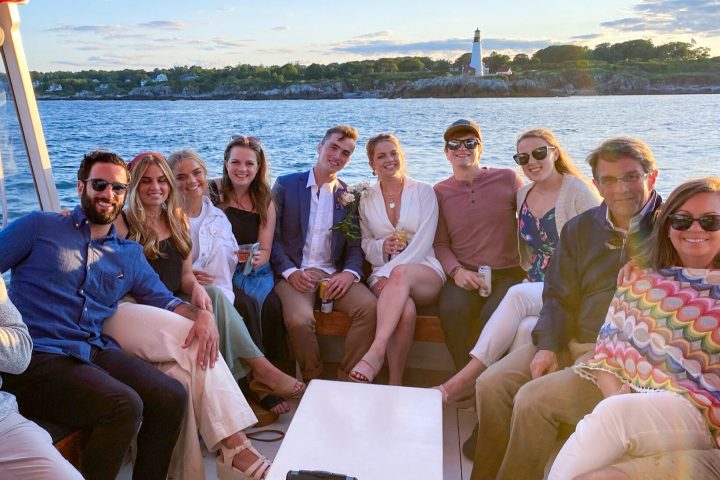 a group of people sitting next to a body of water