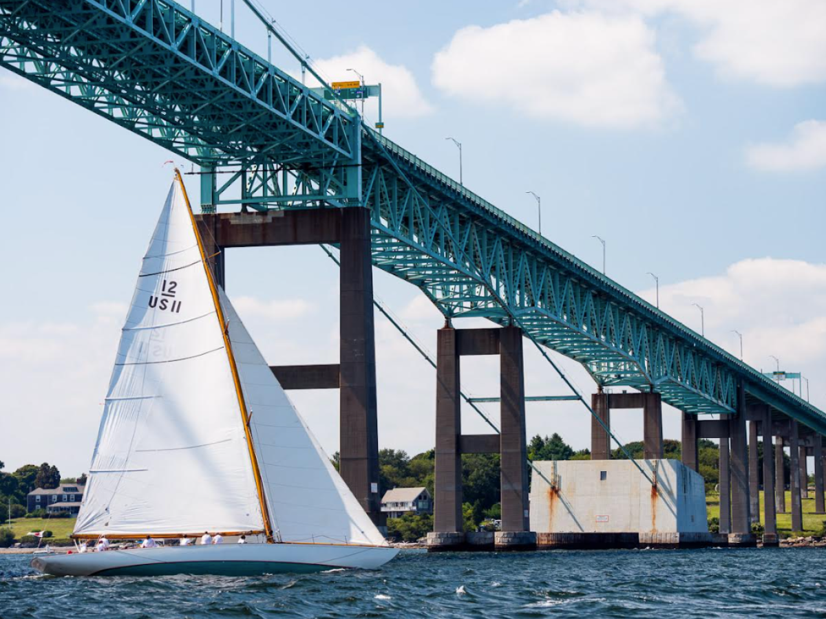 a train crossing a bridge over a body of water