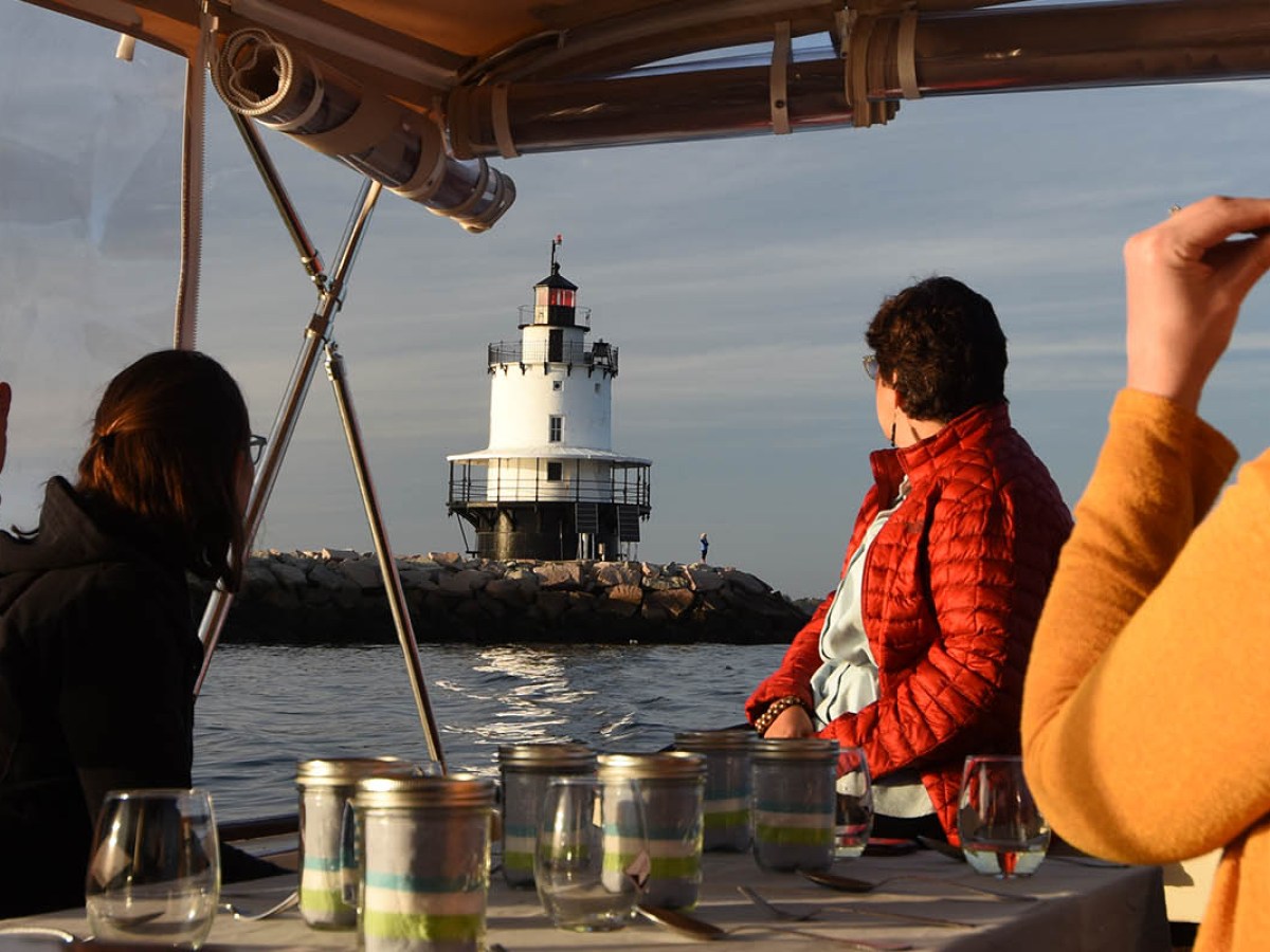 a man and a woman standing in front of a boat