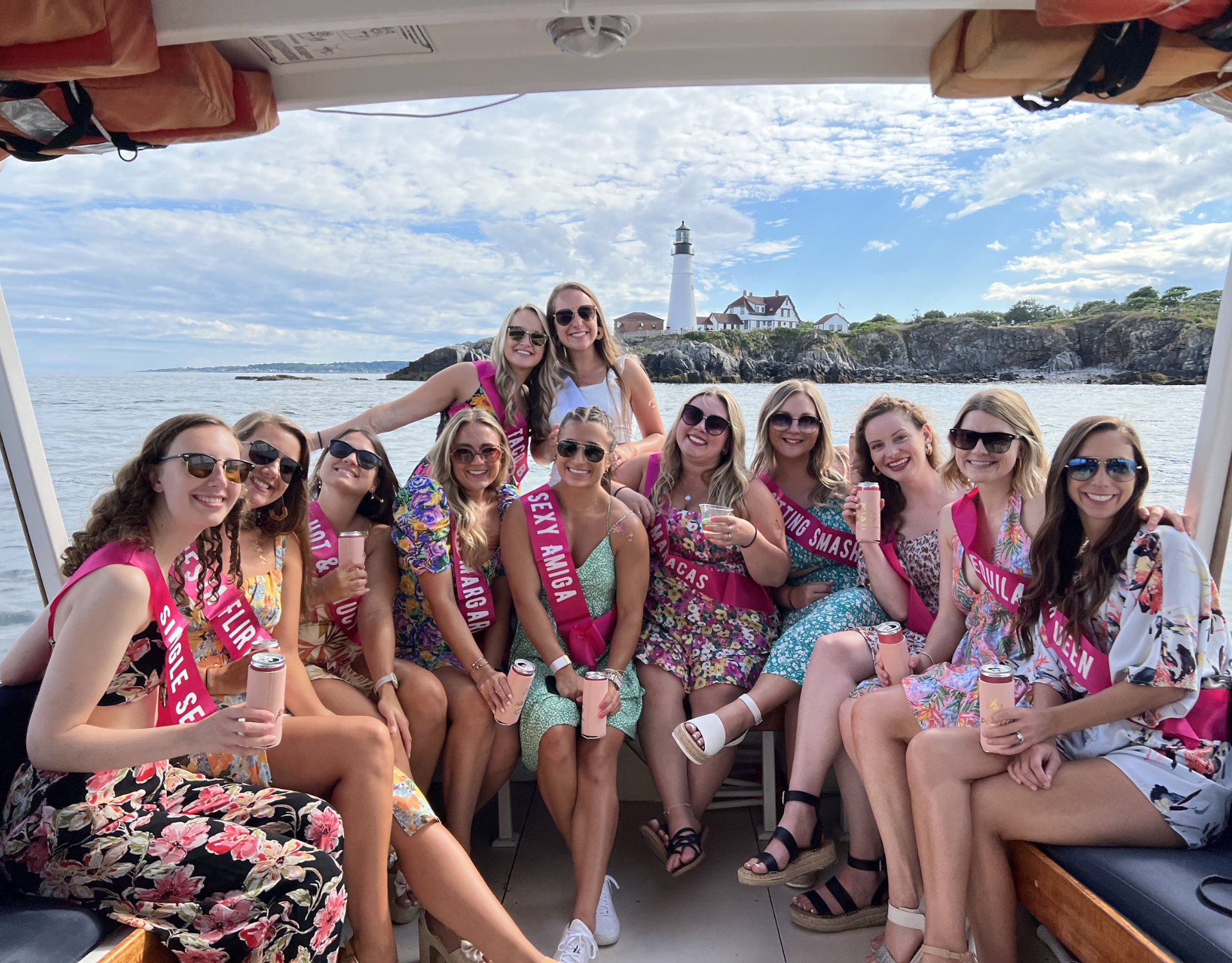Bachelorette Bachelorette Party posing in front of Portland Headlight on a private boat charter.