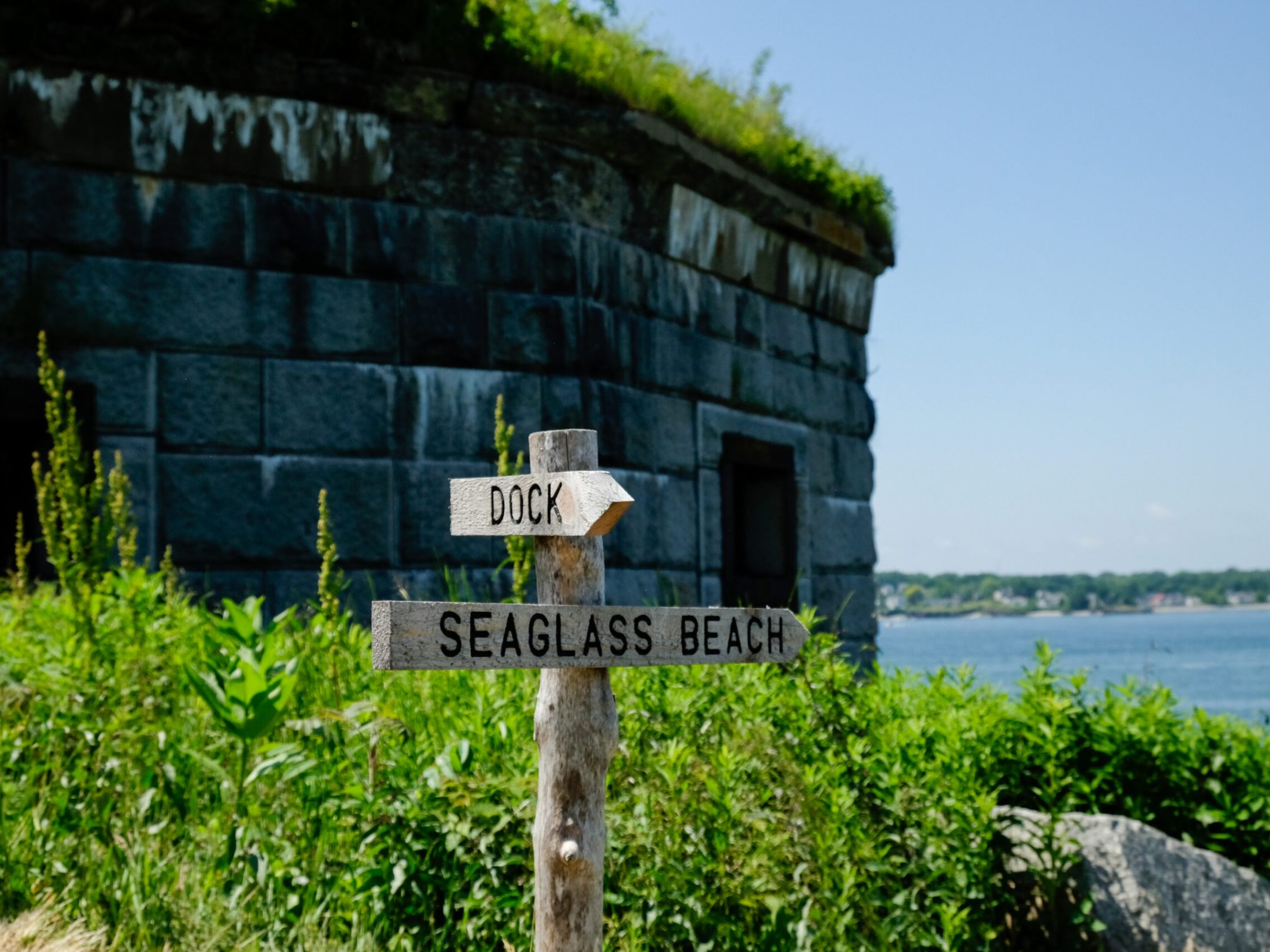 a sign on the side of a river
