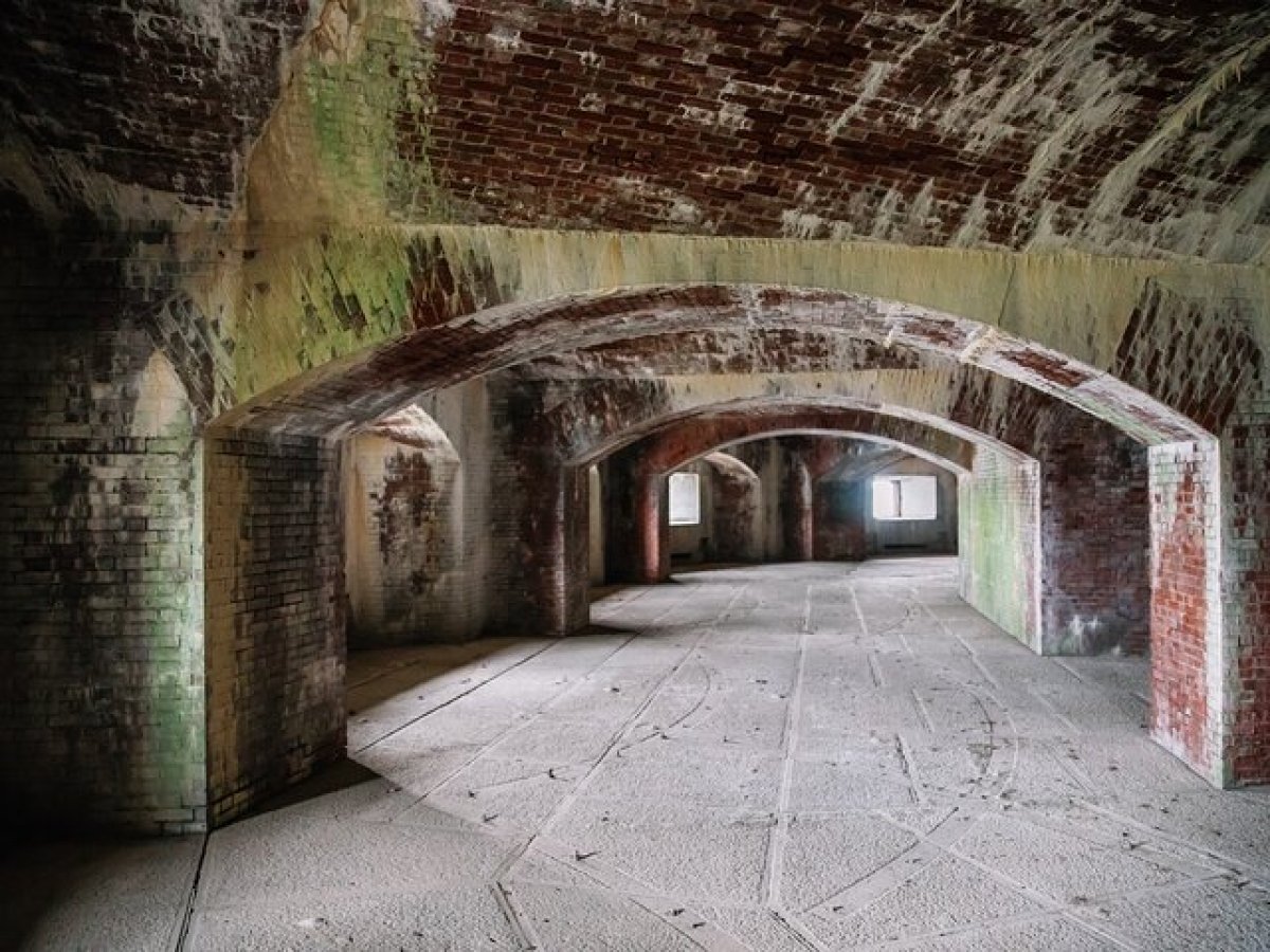 a stone building that has a painting on the wall