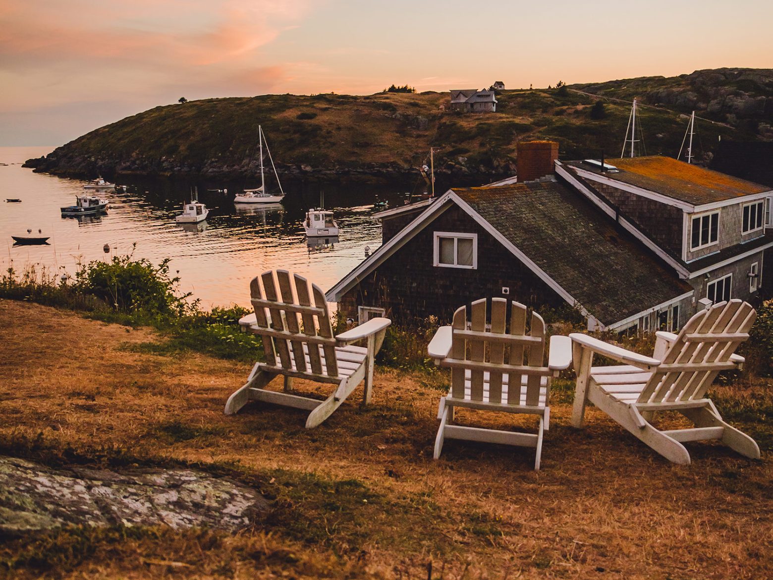 a chair sitting in front of a body of water